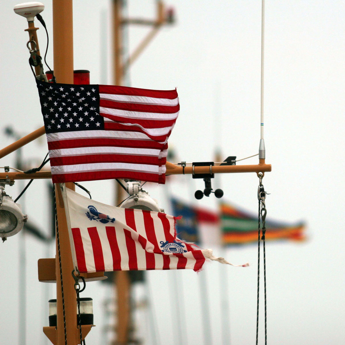 Flags flutter in the wind from the side of sails