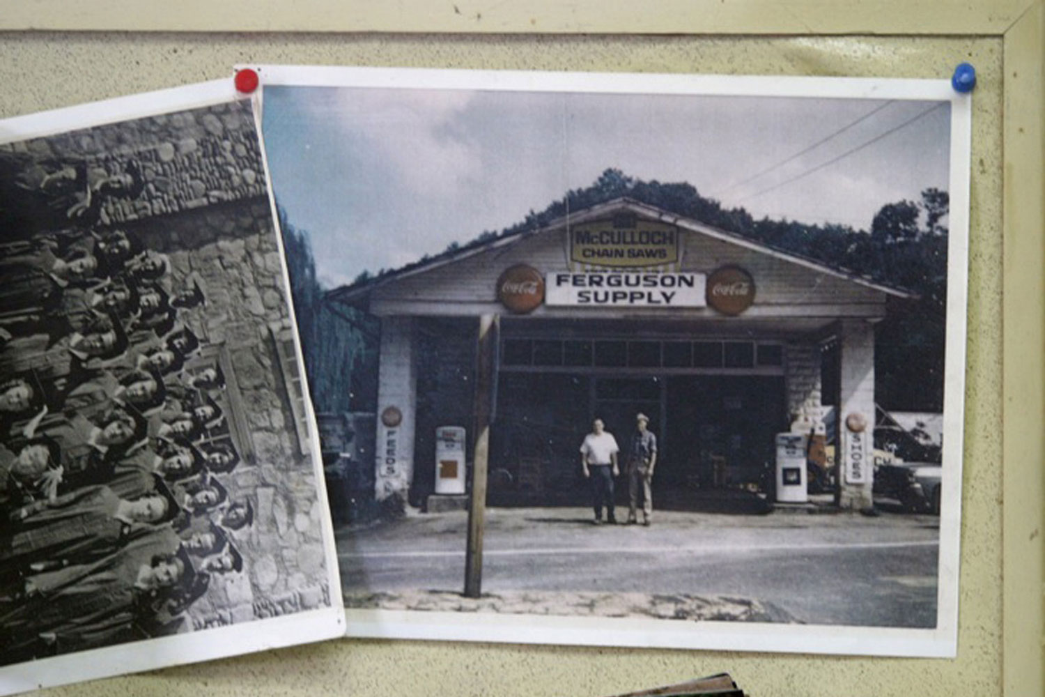 Photographs of an old convenience store thumb tacked to a corkboard