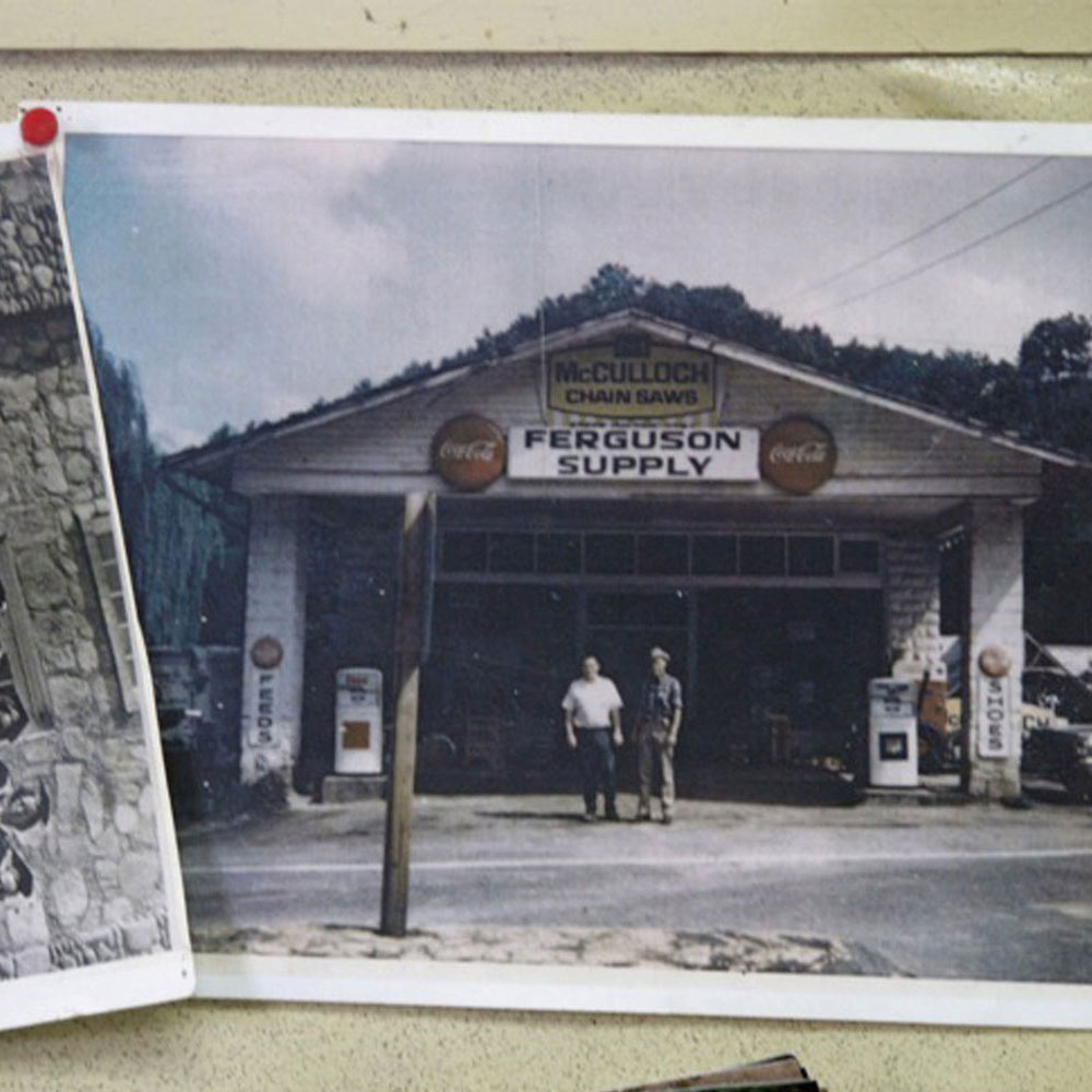 Photographs of an old convenience store thumb tacked to a corkboard
