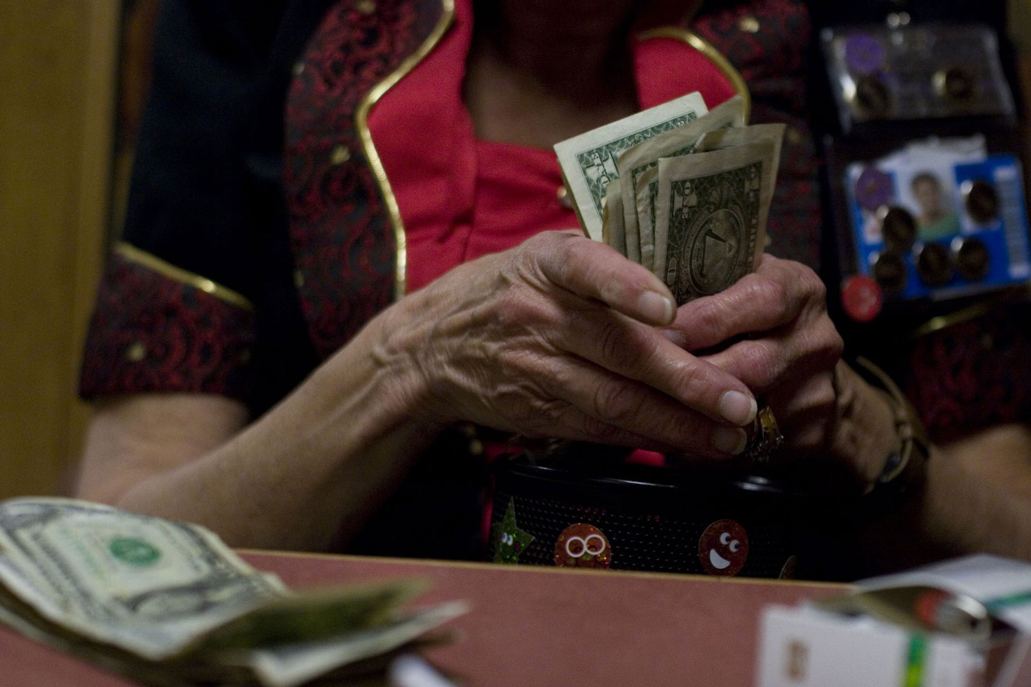 Close up of a woman's hands counting out $1 bills