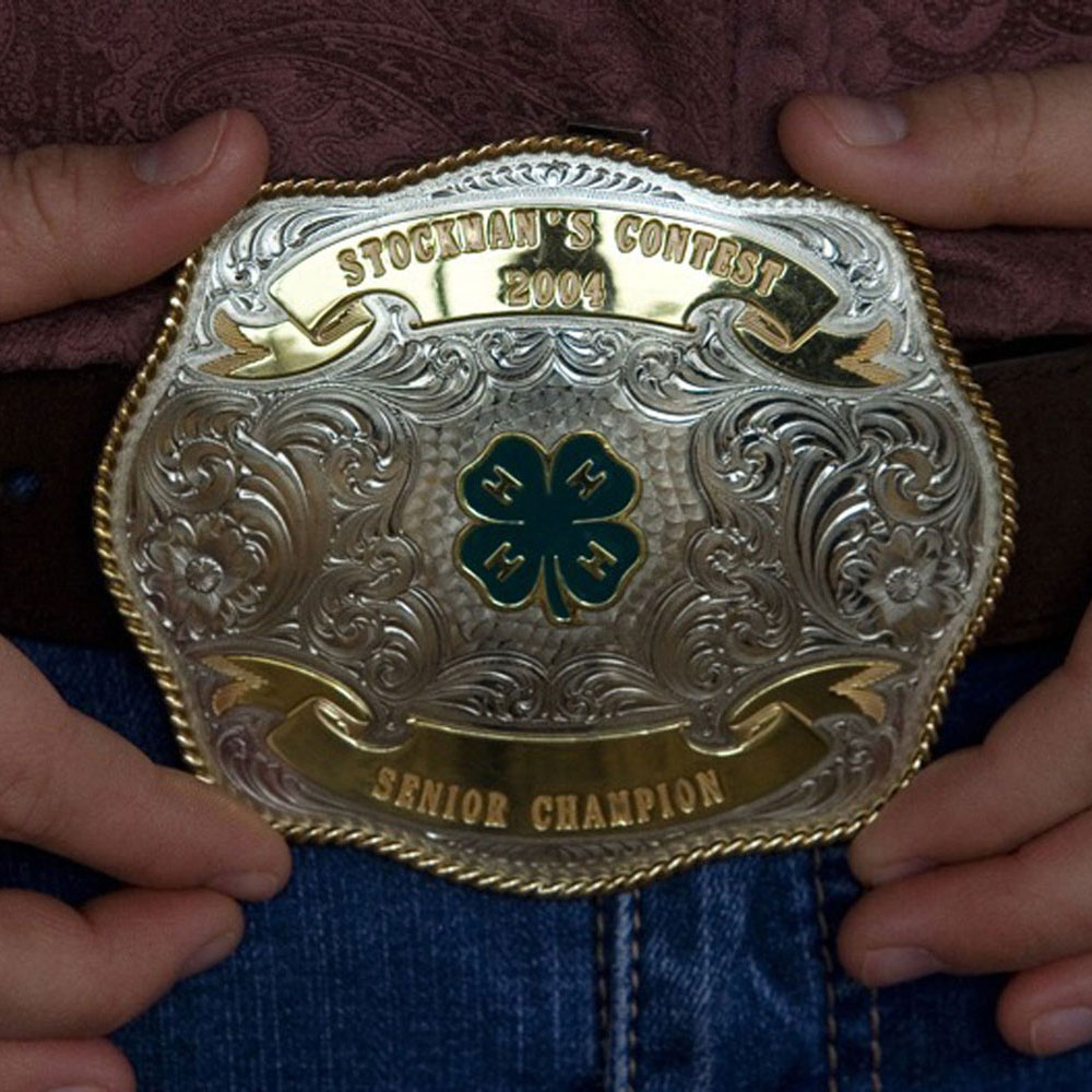 Close up of a belt buckles with the 4H logo