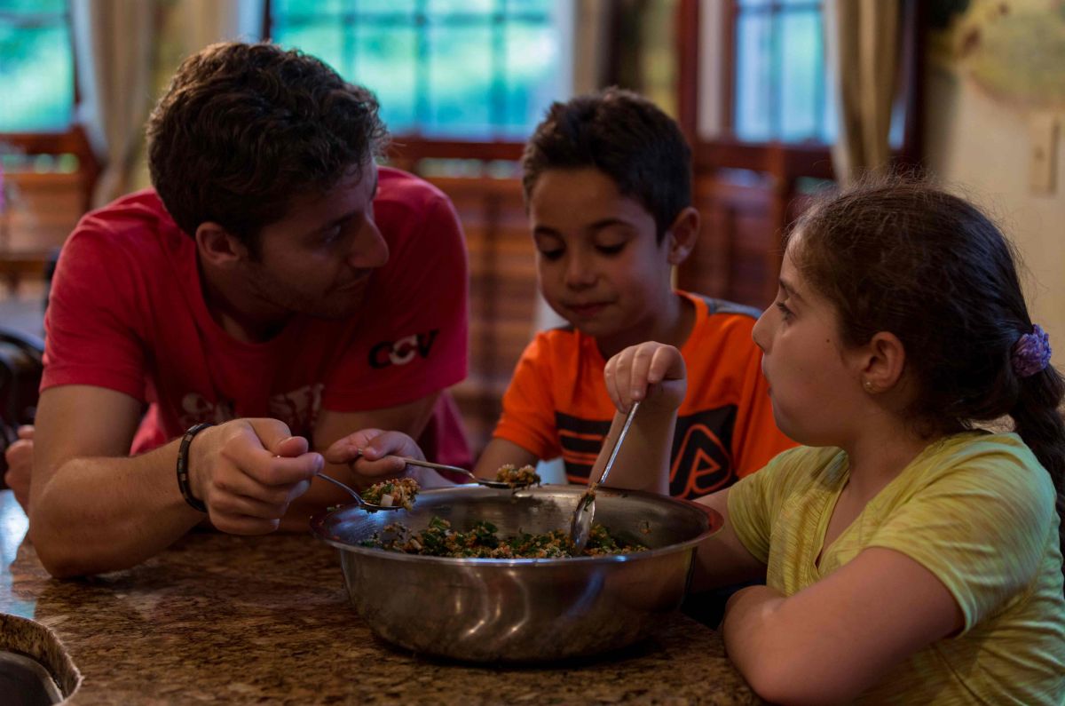 Sami and his cousins Zain, age 7, and Julia, age 9, share a Syrian snack together. Zain, Julia, and their mother Mayada arrived in the U.S. on January 27, 2017, just 6 hours before an executive action put a stop to all immigration from Syria.