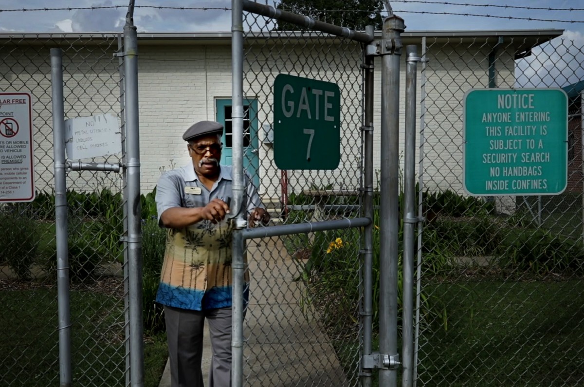 Chaplin, Rev. Reggie Longcrier, opens the gate to Catawba Correctional Center where he once had been an inmate.