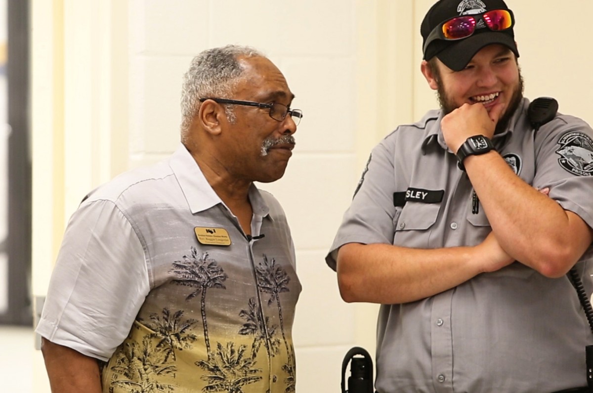 Rev. Reggie Longcrier jokes with a prison guard and an inmate at Catawba Correctional Center.