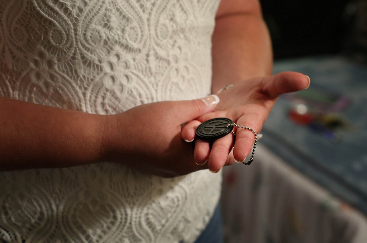 Catie Brown, a recovering drug addict, shows her most prized posession, her multiyear Narcotics Anonymous Chip.