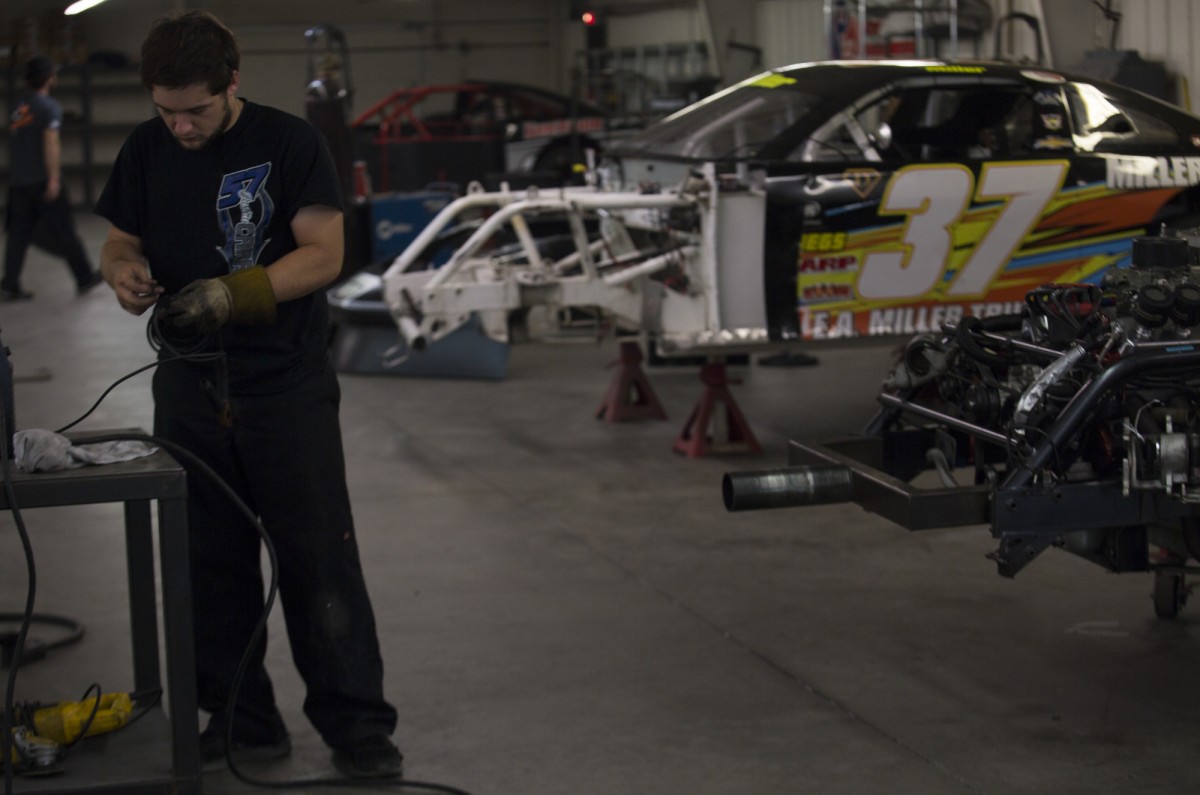 Carroll prepares the tools he needs to fix cars at his job at the Performance Center Racing Warehouse.