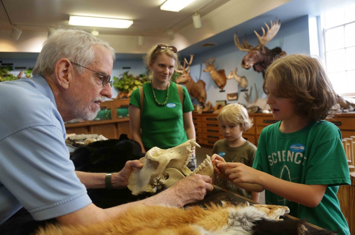9-year-old Tenzin Hartshorn explains the intricacies of a gorilla skull to Bruce.