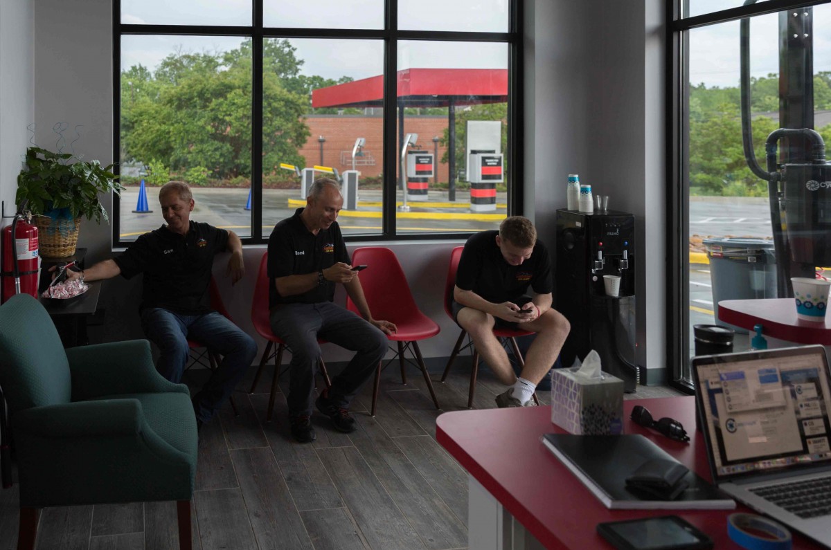 Between car washes, Bassam Alkoutami and Raed Domat hang out in the lobby with their employee Dylan. “There is no boss, no manager,” said Raed. “We are all equal here. We love it, and we work as a family.”
