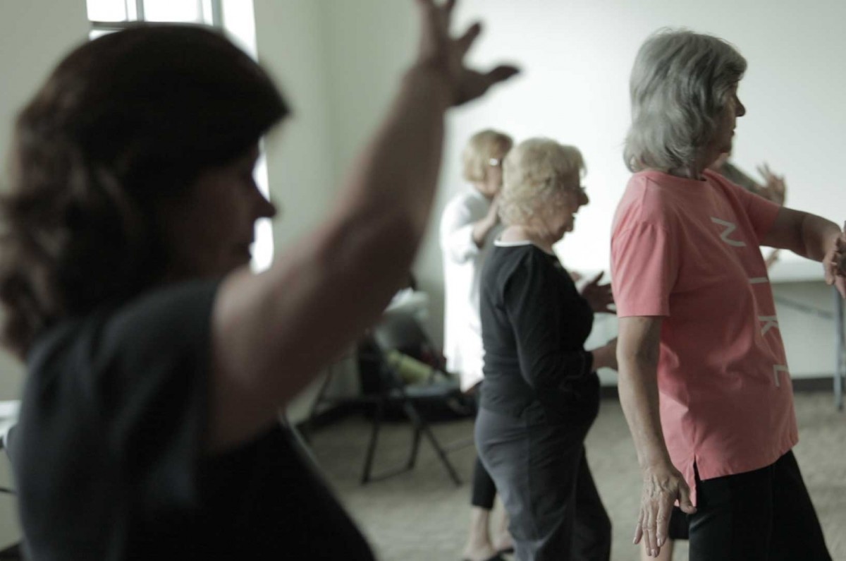 Participants at the Burke Senior Center and Library follow Mary’s movements during a free class on Friday.