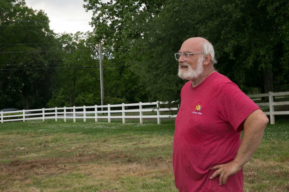 Michael Waltuch, co-owner of Catawba Farms and Carolina Vines, looks over the young vineyard that was planted on the farm a little over a year ago.