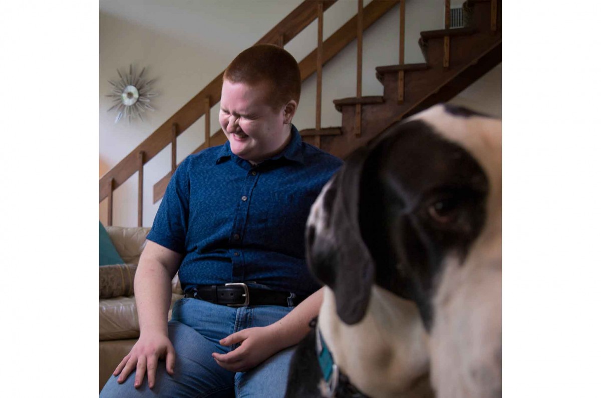 Theo laughs during his CPJW interview as Norbert interrupts to investigate the cameras.