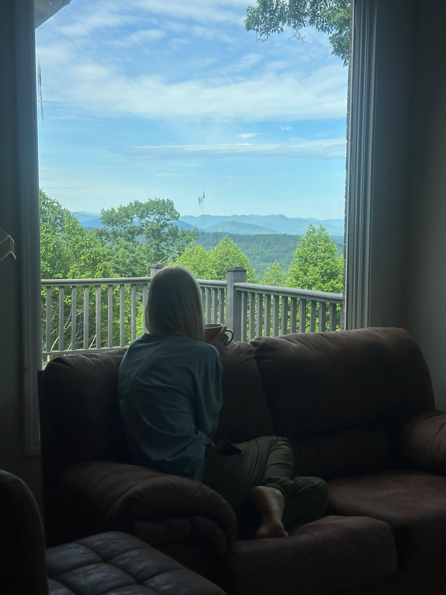 Tegan looking out at the mountains in the CPJW 2025 home.