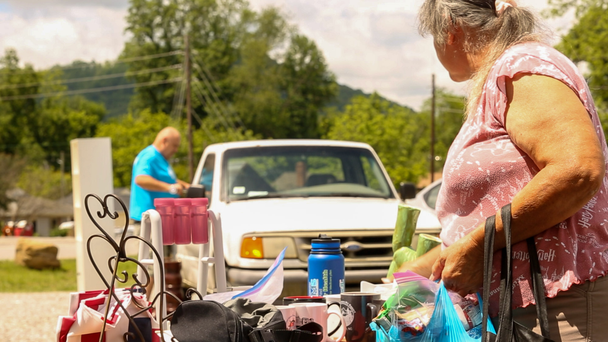 Swannanoa and surrounding Asheville locals stop by the Blessing Barn to collect goods and look around at free items outside the barn.