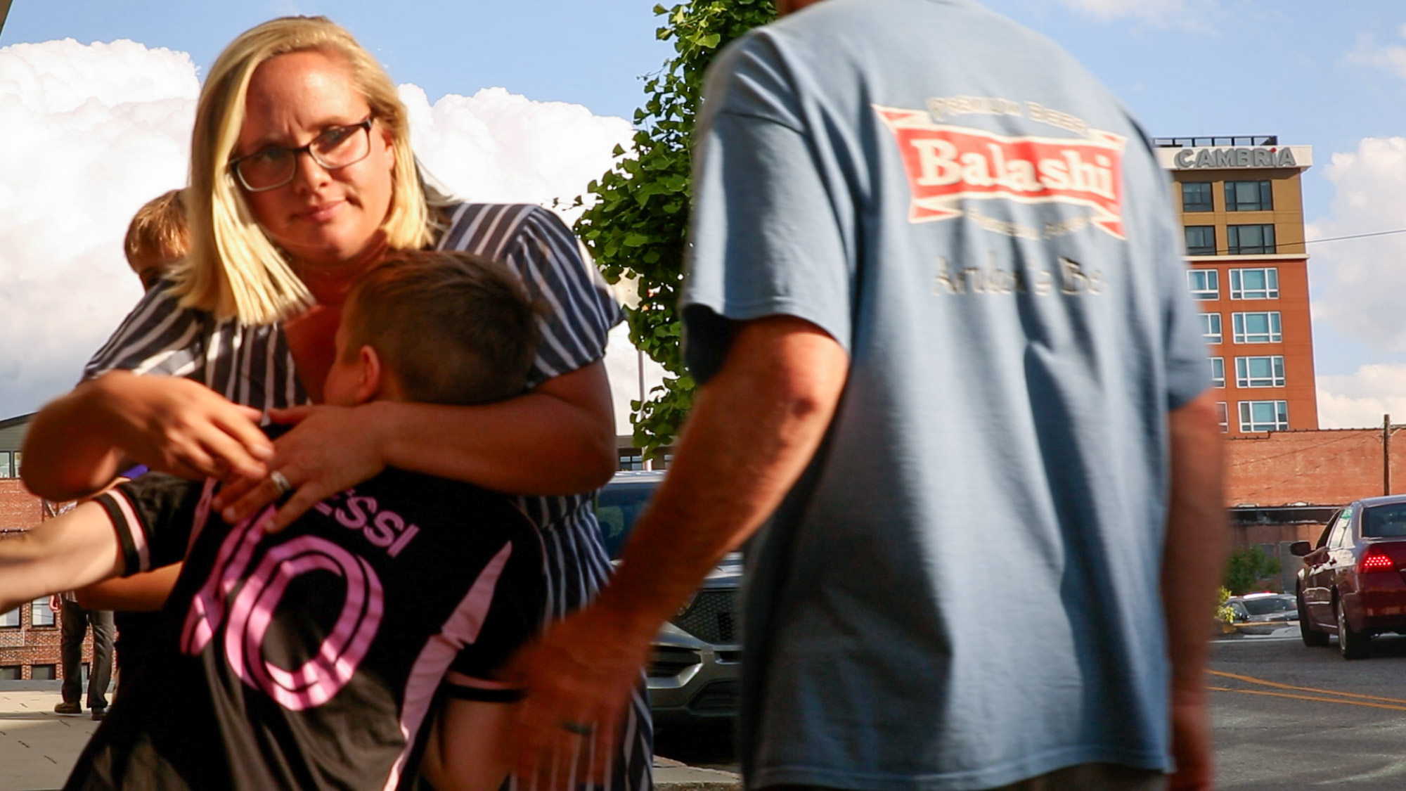Kristen shares a hug with her son, following their prayer at the civic center.