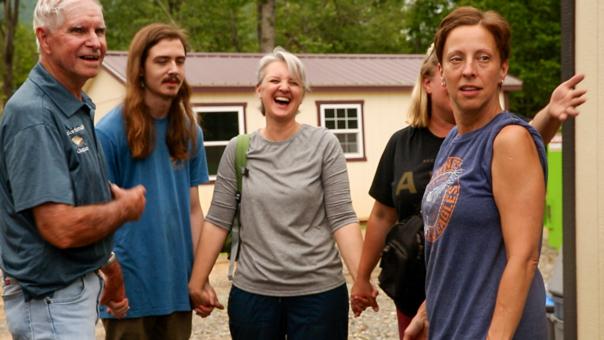 Kristen and her volunteers share a laugh before beginning to pray out for the day at The Blessing Barn.