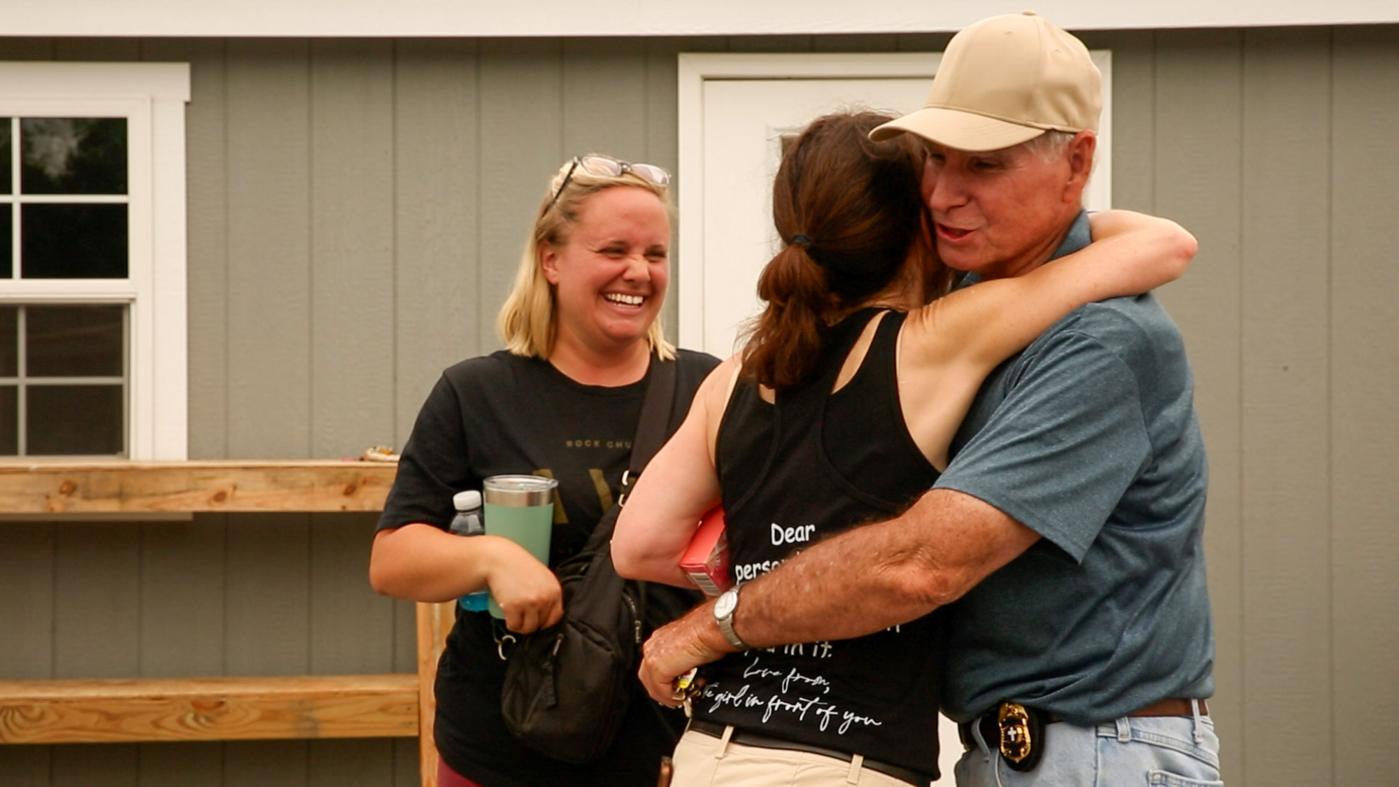 Kristen shares a smile as she watches her volunteers embrace each other after a long day of hard work.