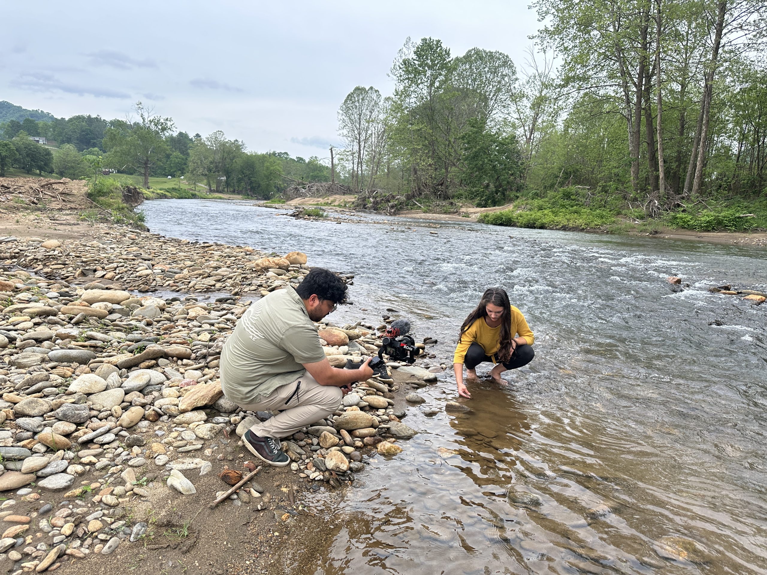 Aayas filming with his story partner at the river.