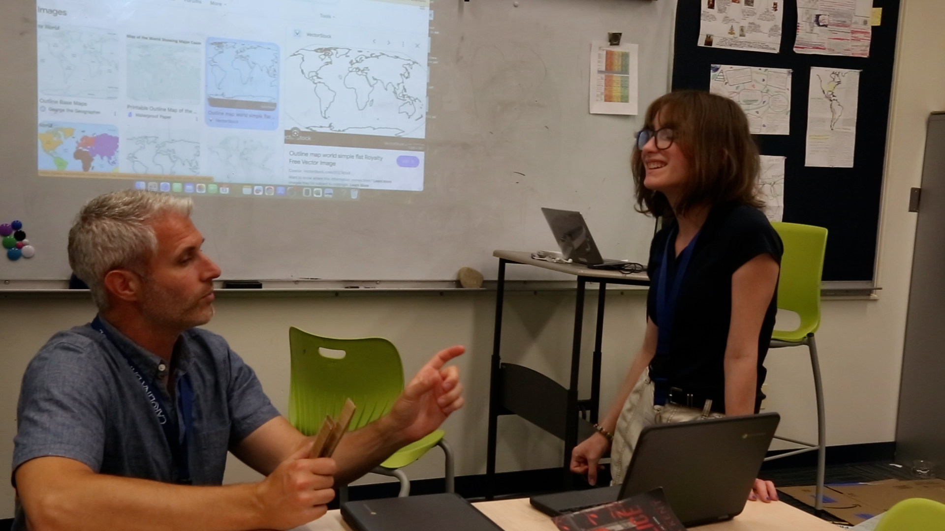 A student smiles as Braketa compliments her project work. “I am going to use yours as an example of what this should be, because nobody has ever created it that well.”