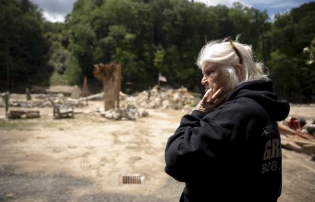 Visiting a Chimney Rock resident, Schneider views the devastation the hurricane left behind.