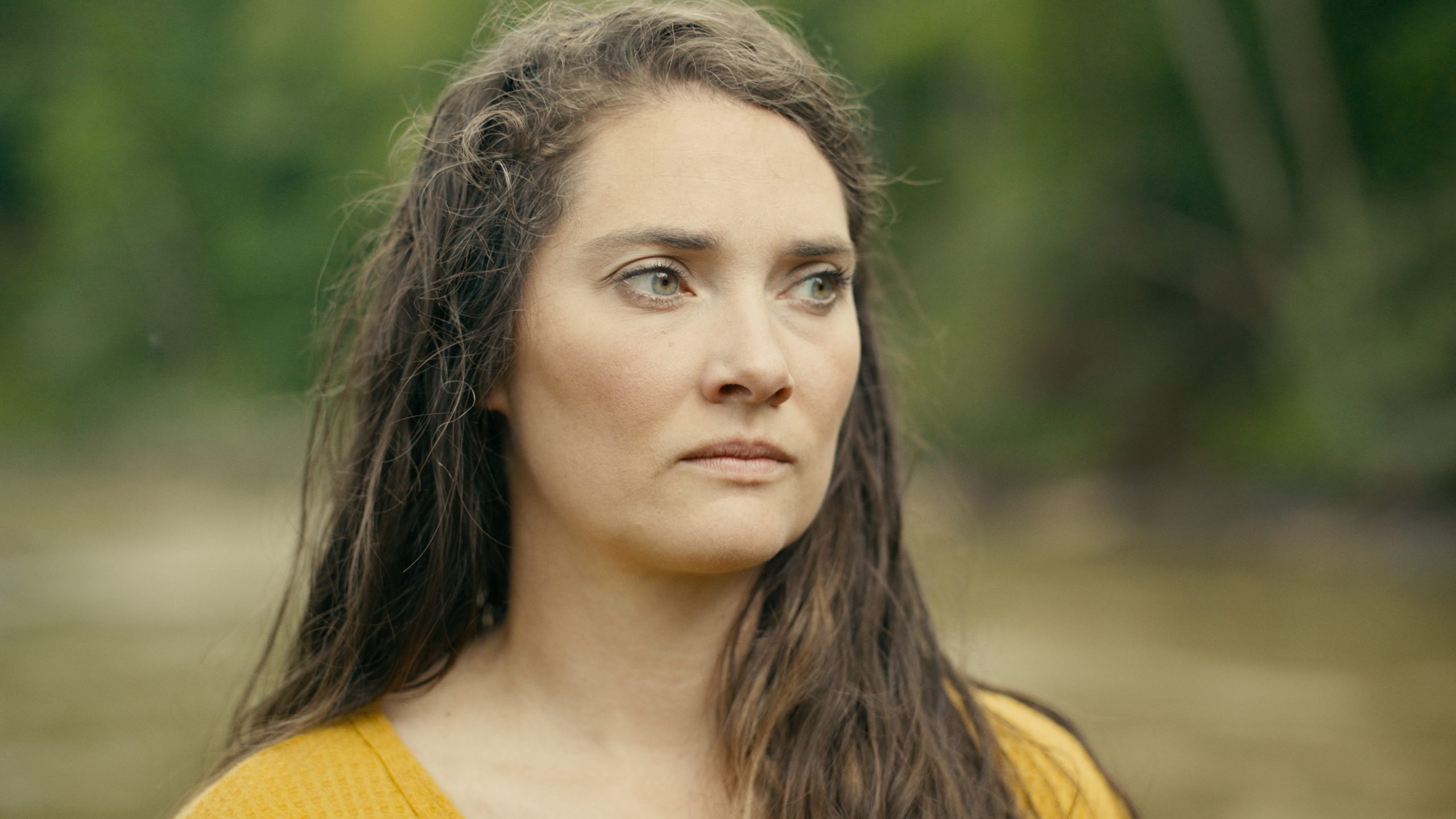 After Hurricane Helene swept away her tiny house and organic farm in Burnsville, N.C., Blair Belt-Clark contemplates her complex relationship with the river that both nurtured and betrayed her family. A close-up portrait of Blair Belt-Clark on the banks of the Cane River as she recalls the aftermath of the flood.