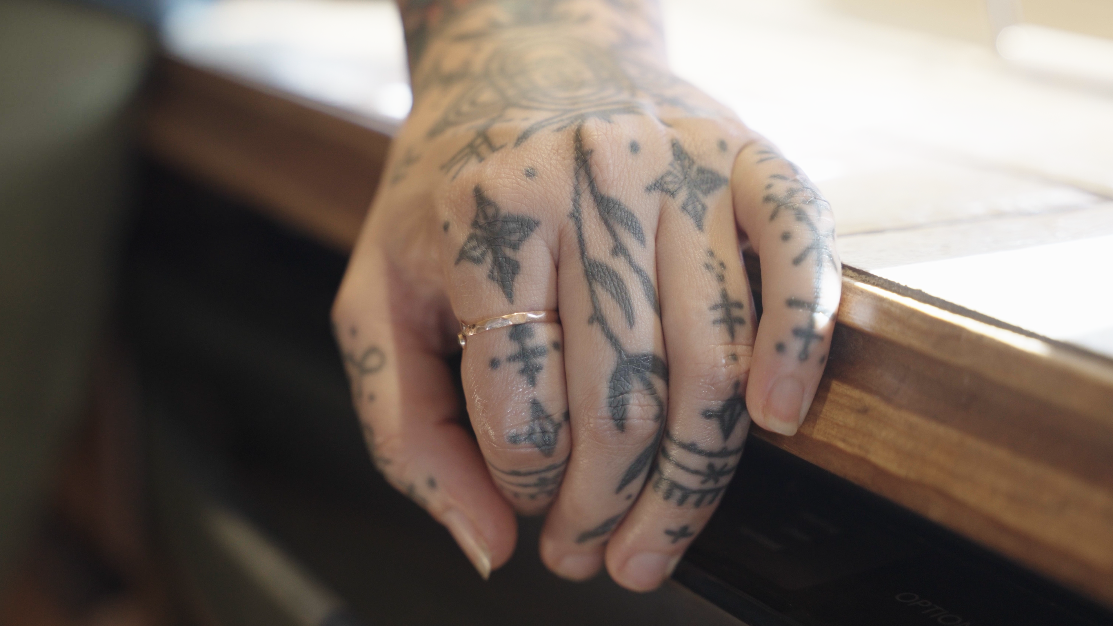Baylen Levore is a tattoo artist and business owner based in Marshall, North Carolina. Her previous studio, housed in an old classroom in Marshall High Studios, was destroyed in the flooding brought by Hurricane Helene. In the wake of the flood, Baylen found new belonging through her family, a rekindling of her love for tattooing, and a ragtag, quirky baseball team.