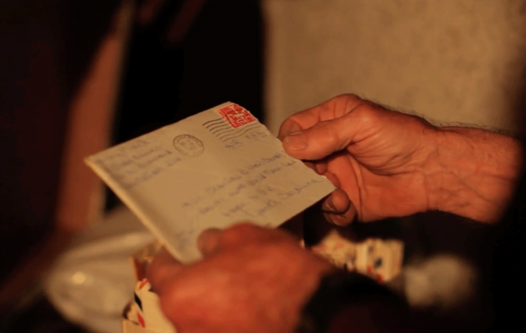 Hands holding an envelope with a letter inside