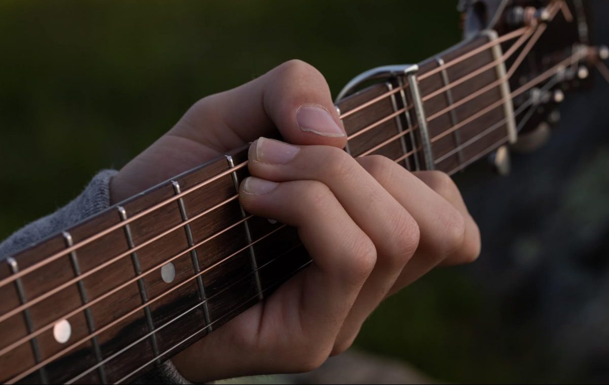 Fingers strumming guitar
